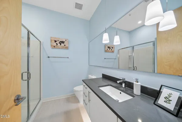 a hallway view with cabinets and wooden floor