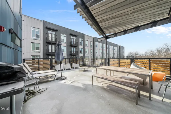 a view of a hall with wooden floor and furniture
