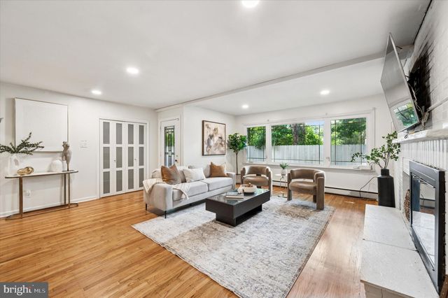 a living room with furniture fireplace and flat screen tv