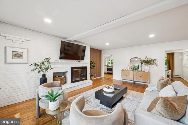a living room with furniture fireplace and a flat screen tv