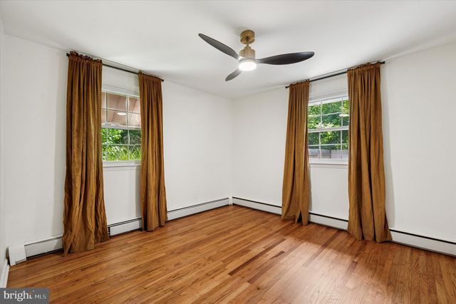 an empty room with wooden floor and a window