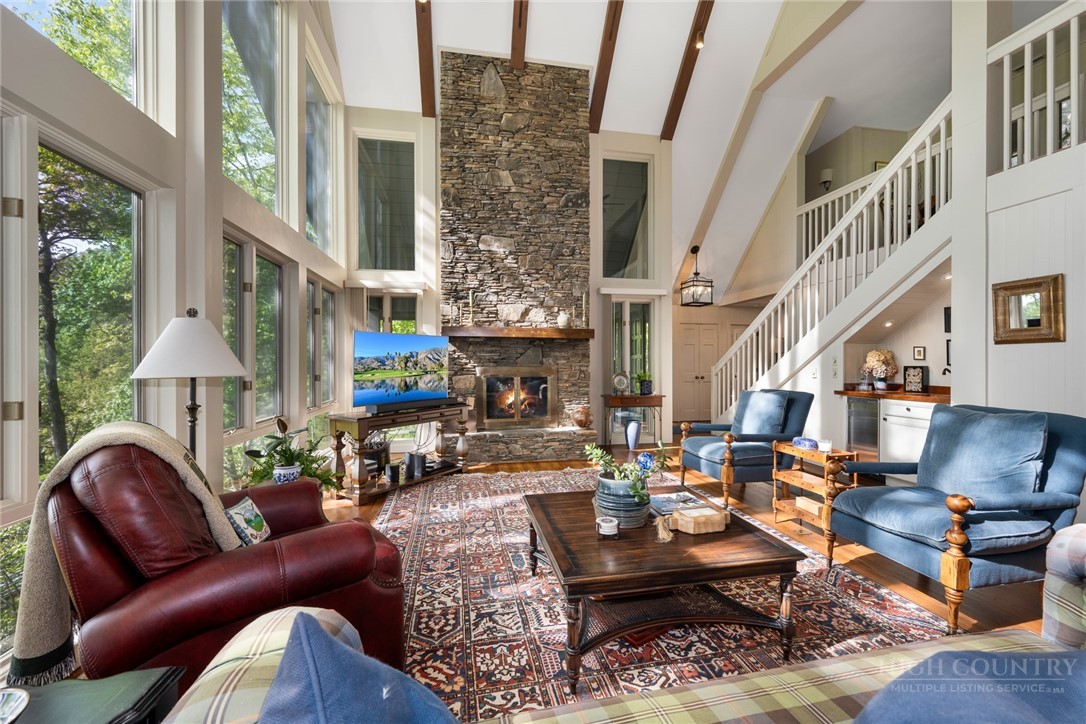 246 Mulberry Lane Boone, NC 28607 - Photo 5 of 49 a living room with patio furniture and a fireplace