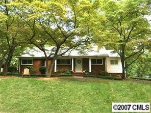 4311 Castlewood Road Charlotte, NC 28209 - Photo 1 of 8 a front view of house with yard and green space