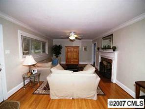 4311 Castlewood Road Charlotte, NC 28209 - Photo 3 of 8 a living room with furniture a fireplace and a table