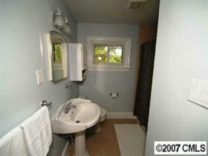 4311 Castlewood Road Charlotte, NC 28209 - Photo 6 of 8 a bathroom with a sink a toilet and mirror