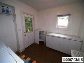 4311 Castlewood Road Charlotte, NC 28209 - Photo 8 of 8 a room with a window and a lamp