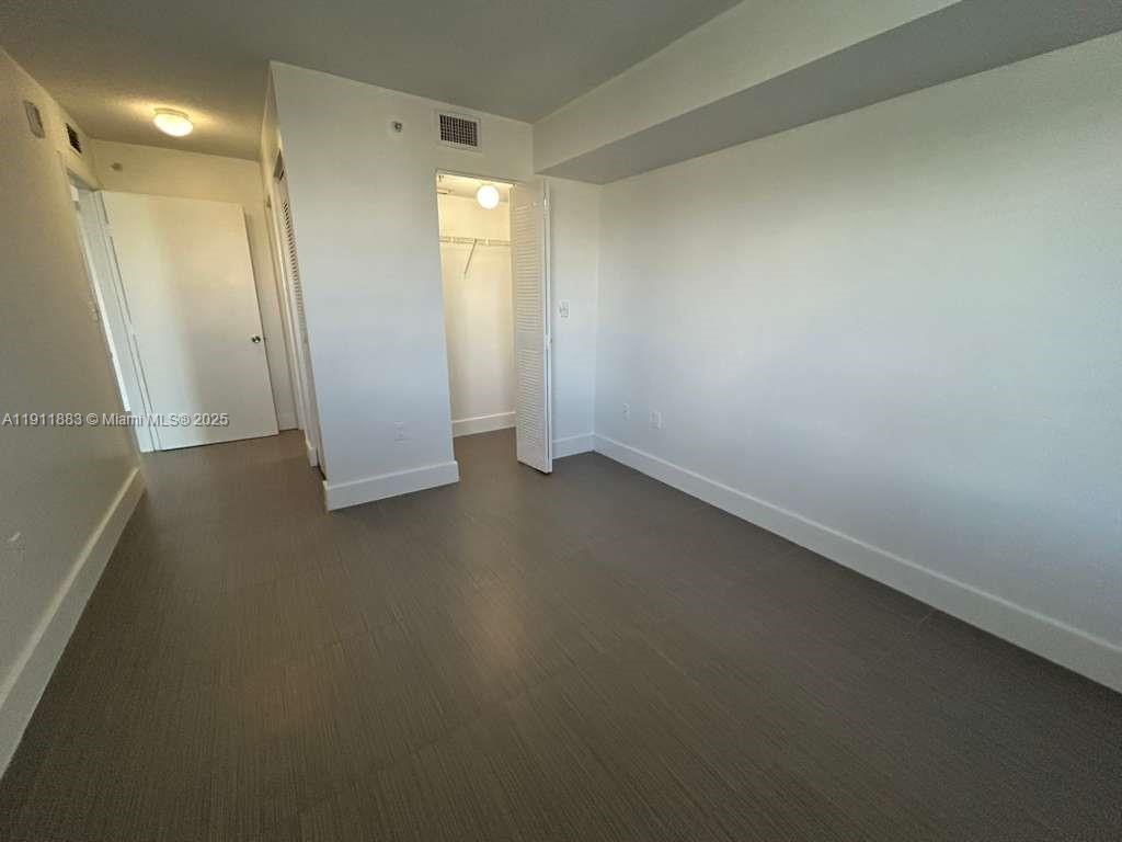 219 Northwest 12th Avenue, Unit 1002 Miami, FL 33128 - Photo 12 of 15 an empty room with windows