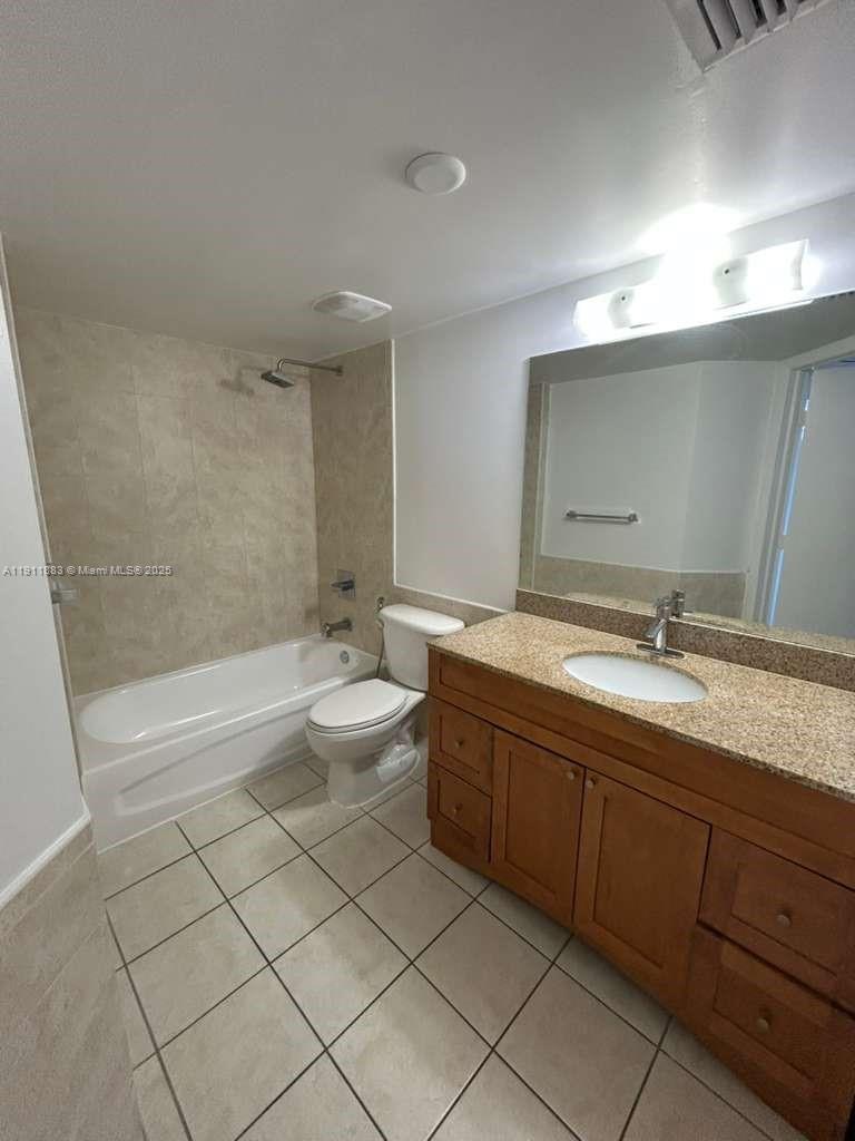 219 Northwest 12th Avenue, Unit 1002 Miami, FL 33128 - Photo 13 of 15 a bathroom with a granite countertop sink mirror and toilet