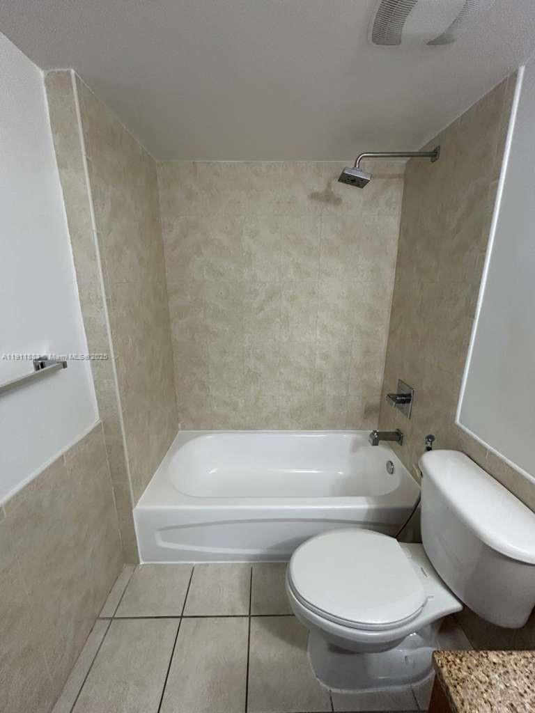219 Northwest 12th Avenue, Unit 1002 Miami, FL 33128 - Photo 14 of 15 a bathroom with a toilet and a shower