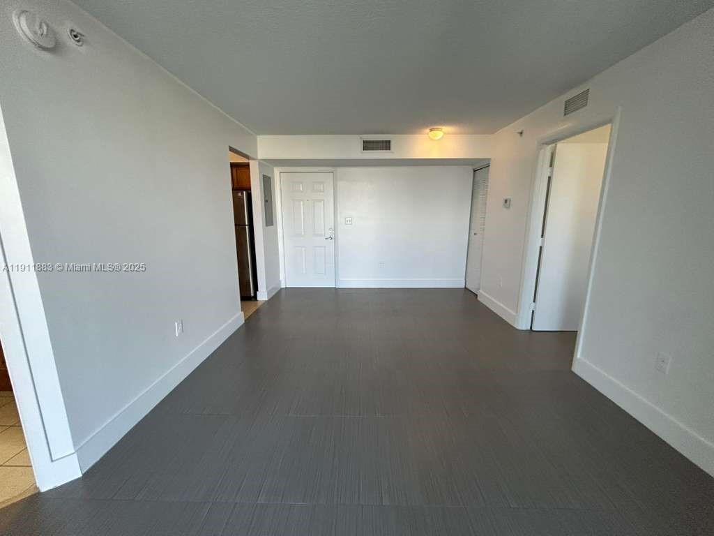 219 Northwest 12th Avenue, Unit 1002 Miami, FL 33128 - Photo 6 of 15 an empty room with a natural light