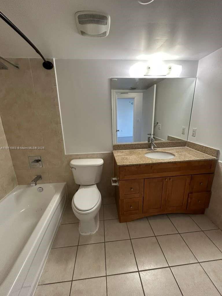 219 Northwest 12th Avenue, Unit 1002 Miami, FL 33128 - Photo 7 of 15 a bathroom with a sink a toilet and mirror