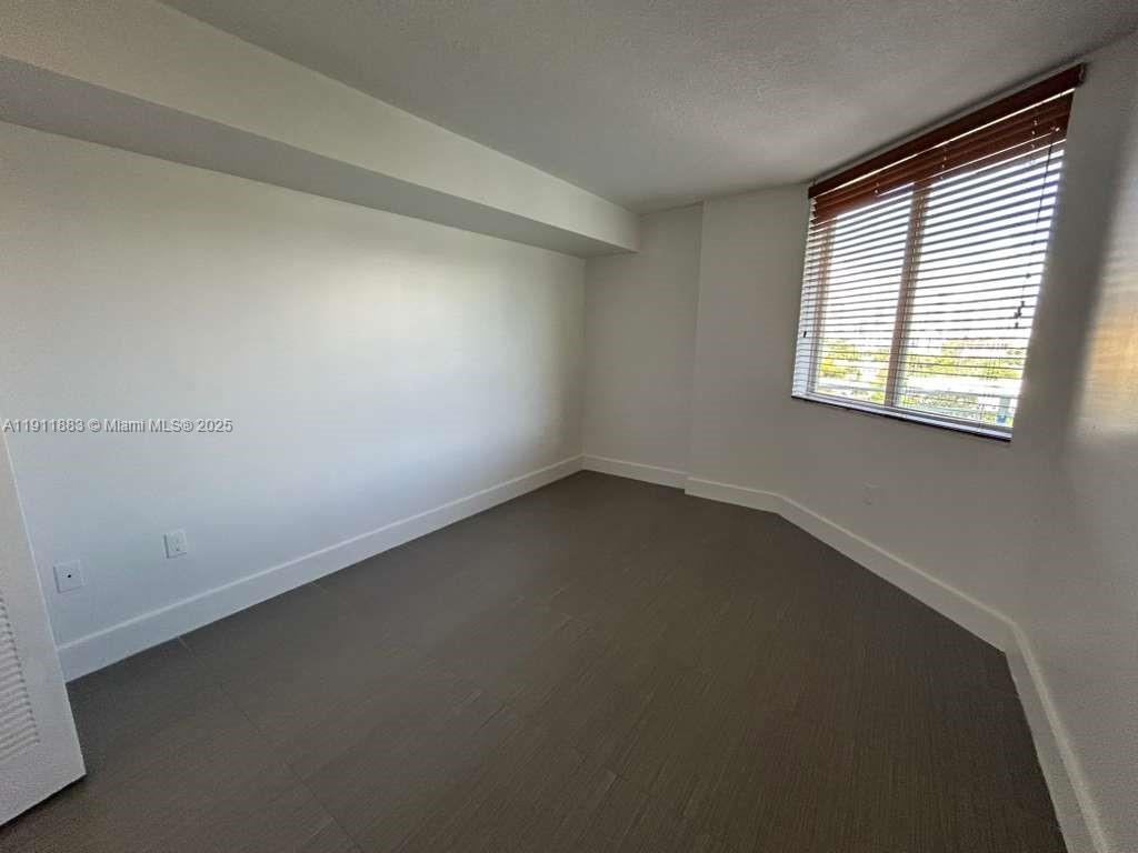 219 Northwest 12th Avenue, Unit 1002 Miami, FL 33128 - Photo 9 of 15 an empty room with a window