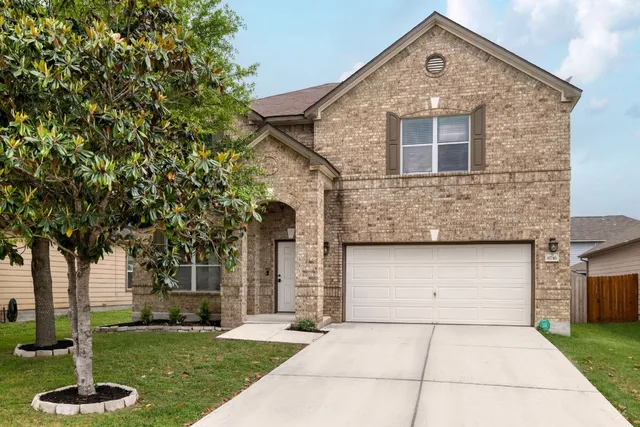 a front view of a house with a yard