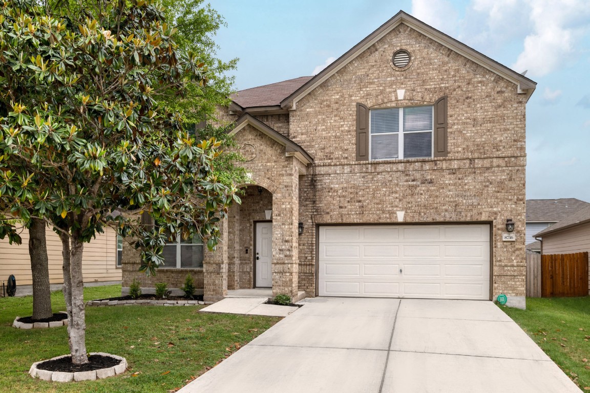 8716 Panadero Drive Austin, TX 78747 - Photo 1 of 36 View of front of home with brick siding, an attached garage, and driveway