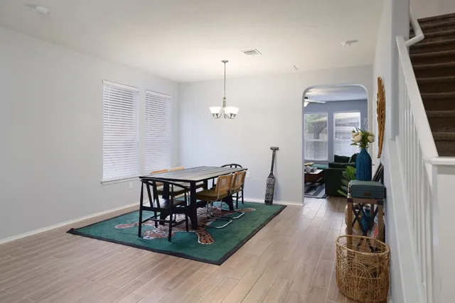 a view of a dining room with furniture and wooden floor