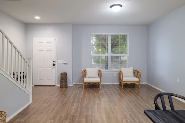 a living room with furniture and a wooden floor