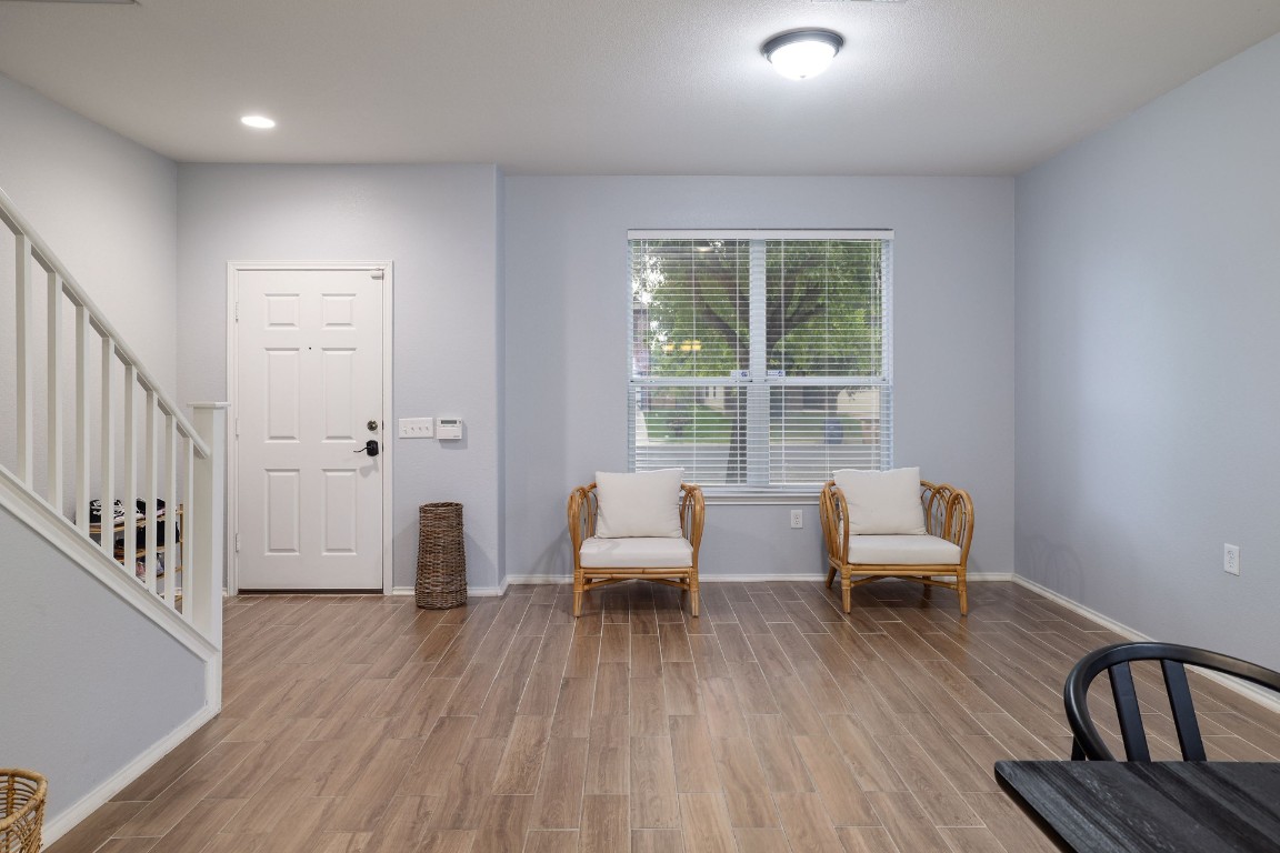 8716 Panadero Drive Austin, TX 78747 - Photo 14 of 36 Sitting room with stairs, wood finished floors, and recessed lighting