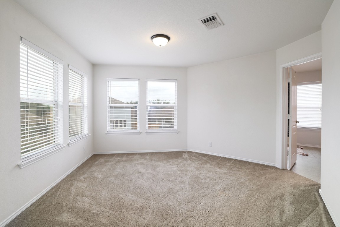 8716 Panadero Drive Austin, TX 78747 - Photo 20 of 36 Unfurnished room featuring light colored carpet and baseboards