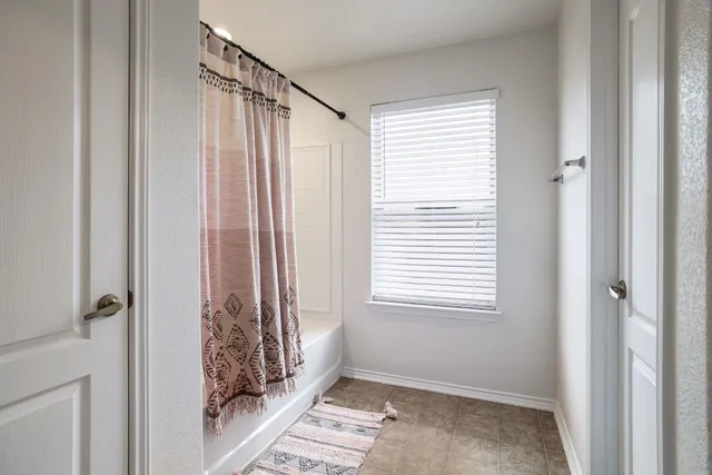 a view of a bathroom with a window and a bathroom