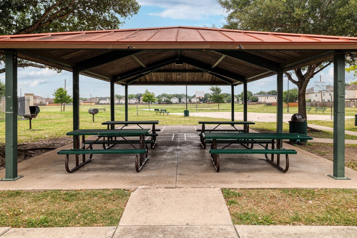 8716 Panadero Drive Austin, TX 78747 - Photo 36 of 36 View of community featuring a yard, a patio, and a residential view