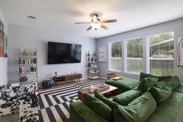a living room with furniture and a flat screen tv