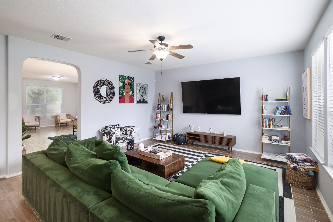 8716 Panadero Drive Austin, TX 78747 - Photo 5 of 36 Living room featuring wood finished floors, arched walkways, and ceiling fan