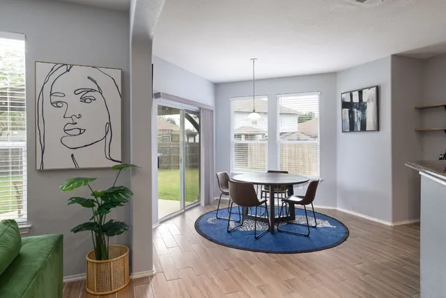 a dining room with furniture a potted plant and a chandelier