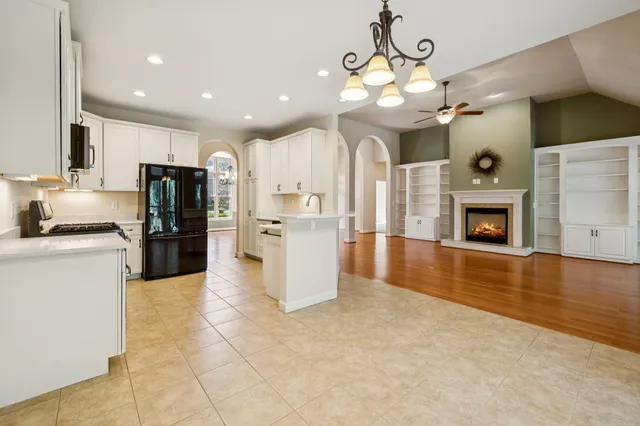 a kitchen with stainless steel appliances granite countertop a sink and a stove