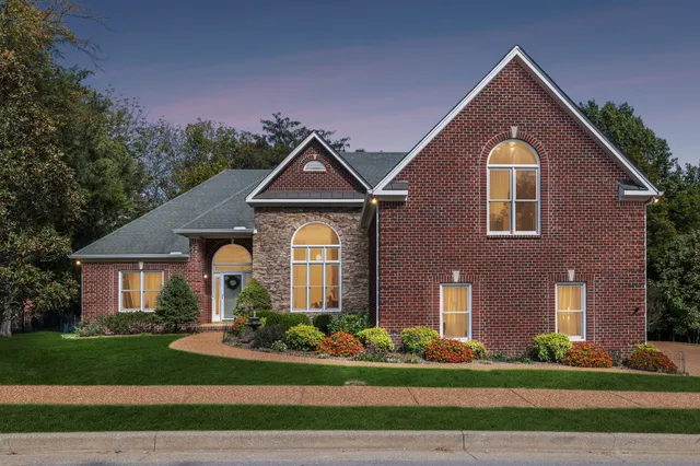 a front view of a house with a yard