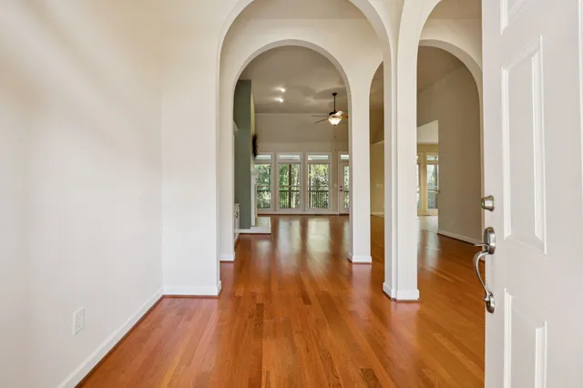 a view of empty room with wooden floor and fireplace