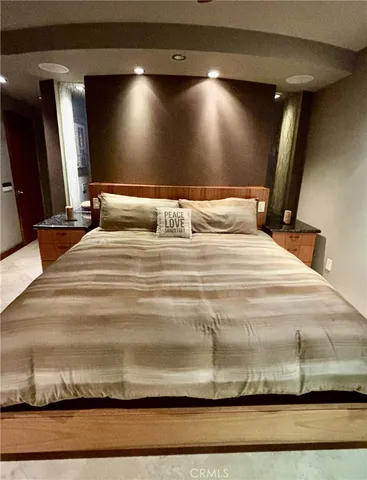 a bedroom with a bed and ceiling fan