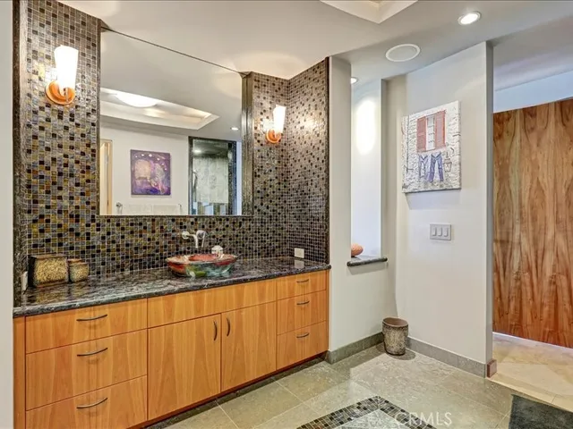 a bathroom with a sink a mirror and shower