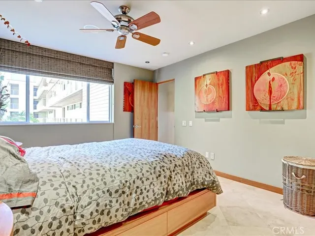 a bedroom with a bed and a painting on the wall