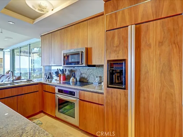 a kitchen with granite countertop wood cabinets and a sink
