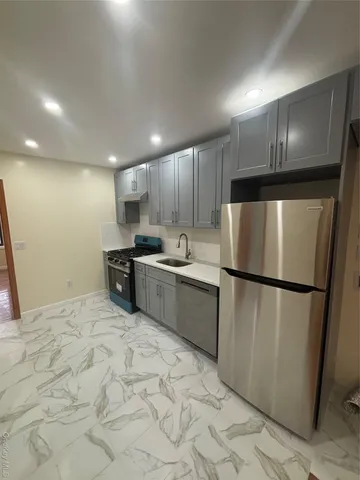 a kitchen with stainless steel appliances granite countertop a refrigerator sink and cabinets