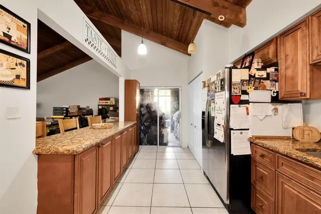 a large kitchen with stainless steel appliances granite countertop lots of counter top space