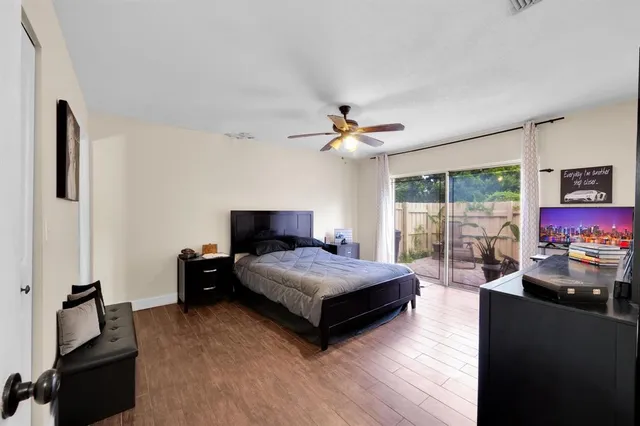 a living room with a bed furniture and a flat screen tv