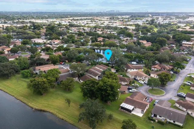 an aerial view of residential houses with outdoor space and swimming pool