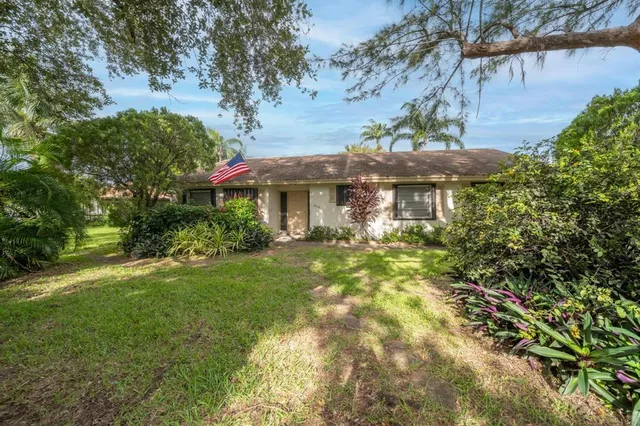 a patio with table and chairs under an umbrella