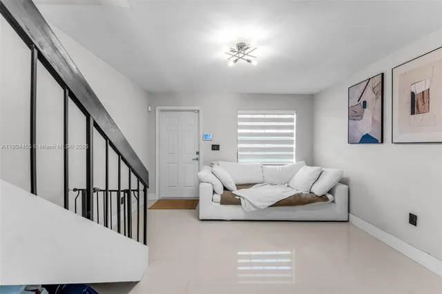a living room with furniture and stairs