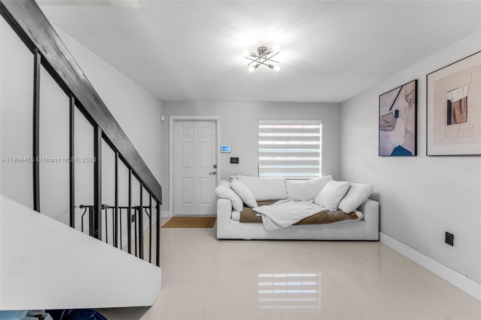 13350 Southwest 58th Terrace, Unit 38 Miami, FL 33183 - Photo 1 of 8 a living room with furniture and stairs