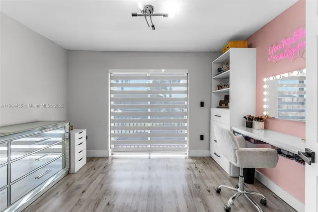 a view of a livingroom with furniture hardwood floor and a window