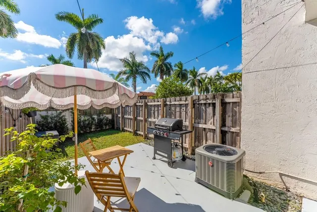 a view of a chairs and table in backyard