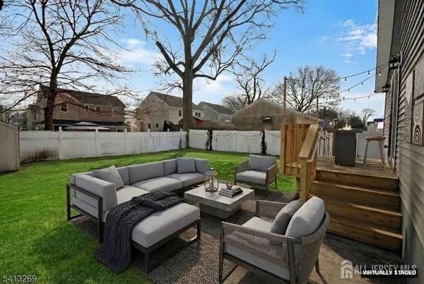 a view of a yard with furniture and a fire pit
