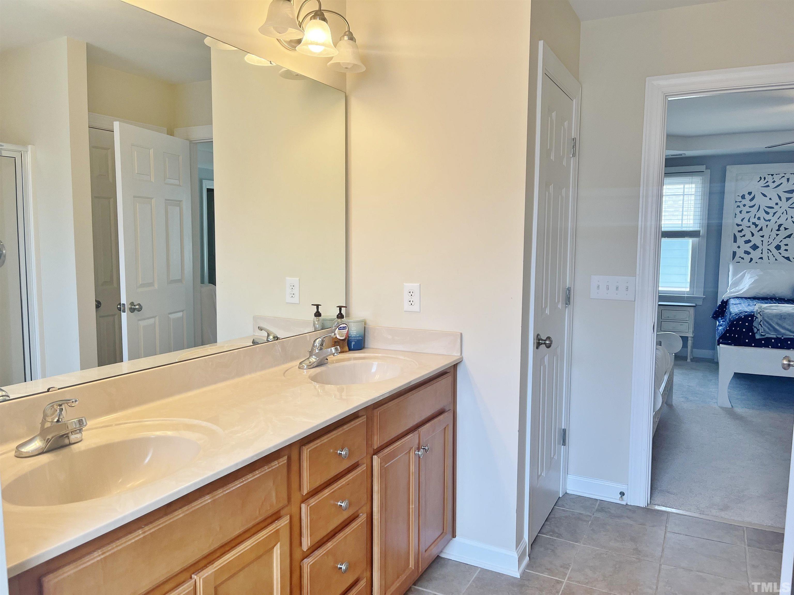 2223 Cloud Cover Lane Raleigh, NC 27614 - Photo 12 of 26 a bathroom with a sink double vanity and a mirror