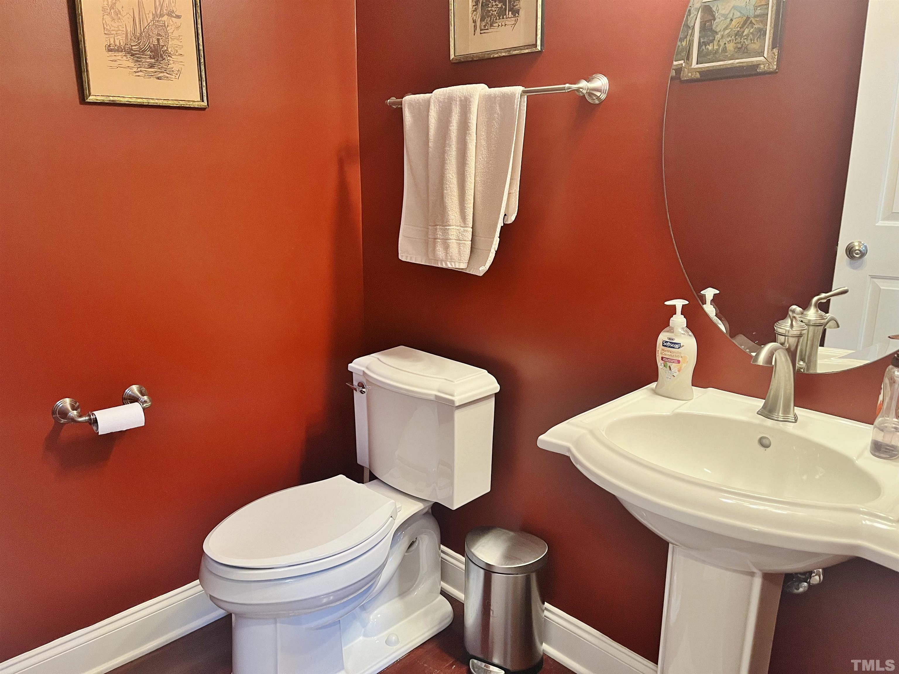 2223 Cloud Cover Lane Raleigh, NC 27614 - Photo 17 of 26 a white toilet sitting next to a bathroom sink