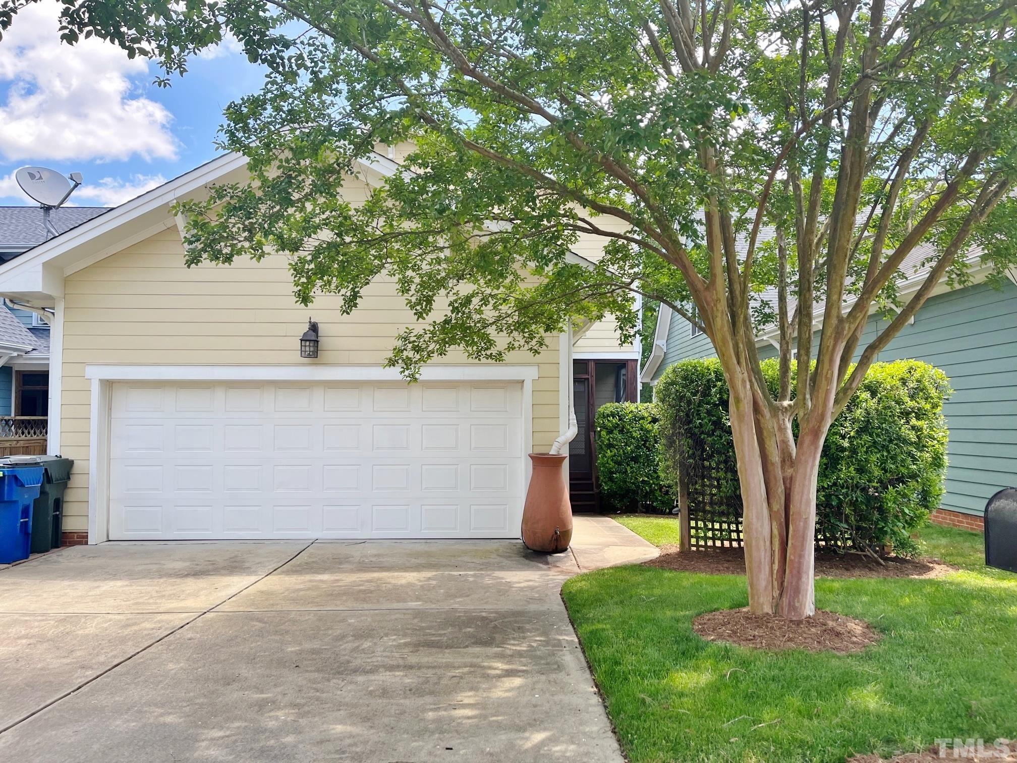 2223 Cloud Cover Lane Raleigh, NC 27614 - Photo 21 of 26 a front view of a house with a garden and tree