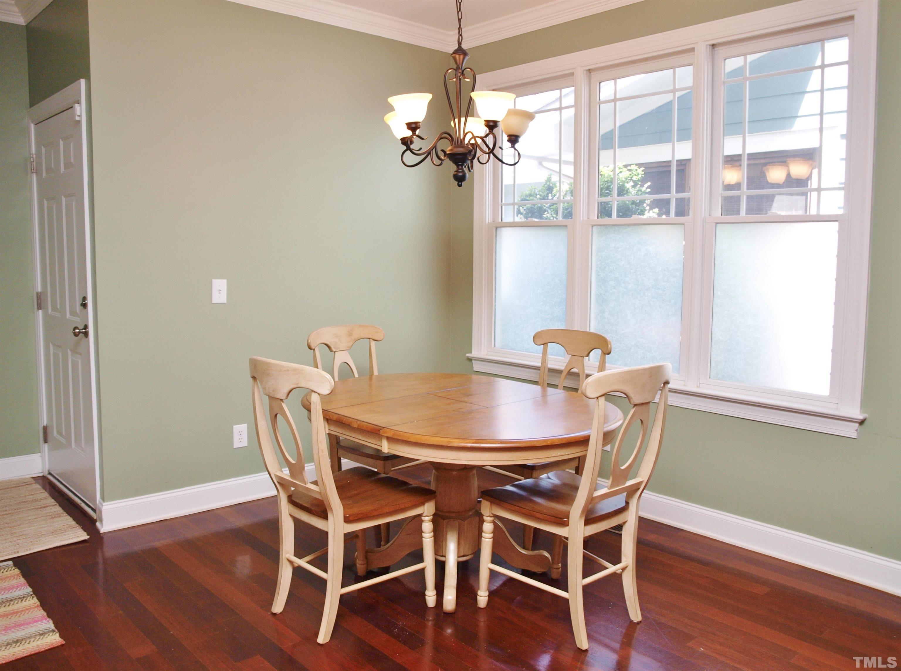 2223 Cloud Cover Lane Raleigh, NC 27614 - Photo 9 of 26 a view of a dining room with furniture wooden floor and chandelier