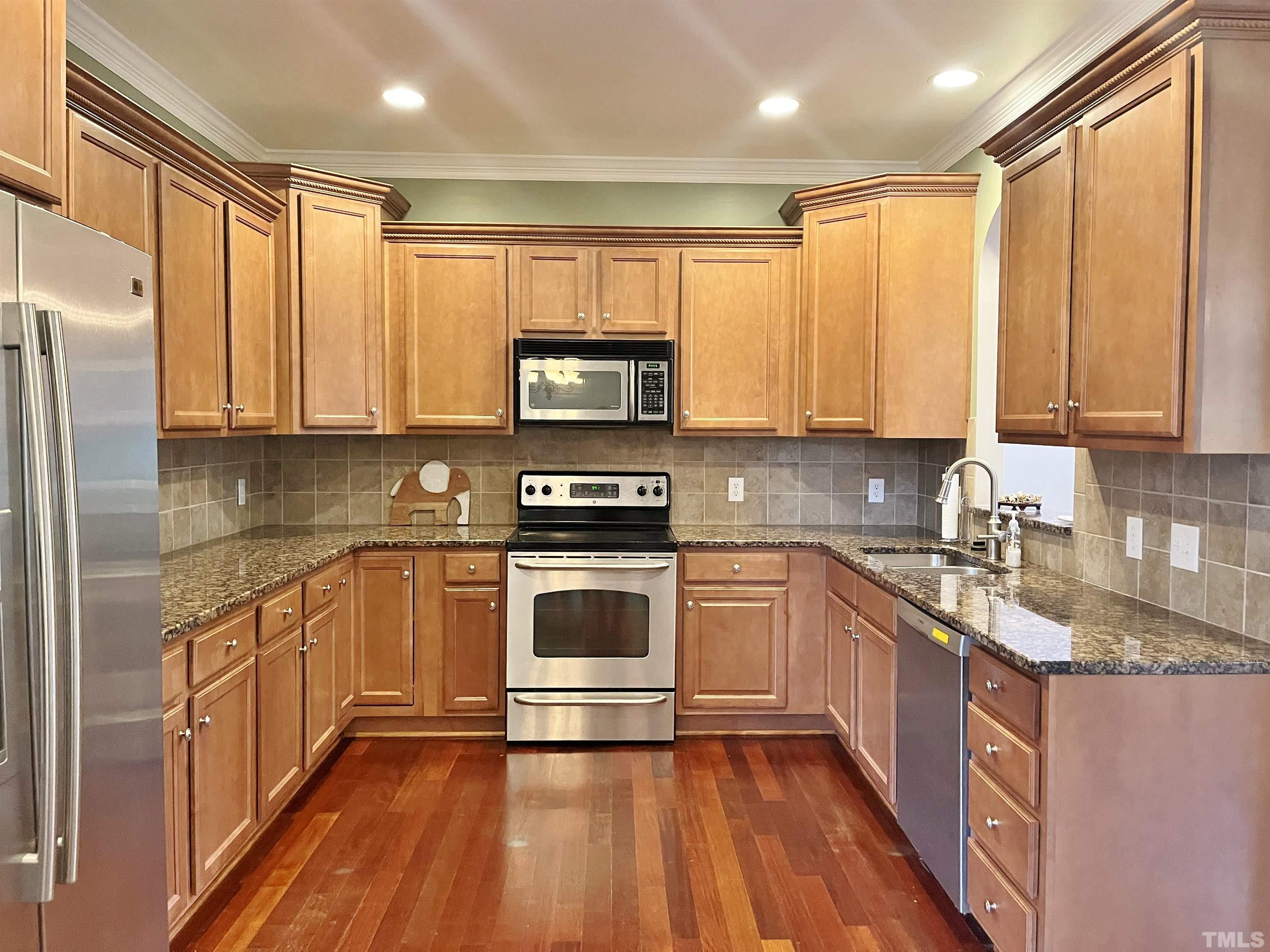2223 Cloud Cover Lane Raleigh, NC 27614 - Photo 10 of 26 a kitchen with stainless steel appliances granite countertop a stove a sink and a refrigerator