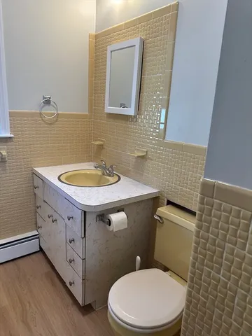 a bathroom with a sink a toilet and mirror